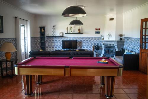 a living room with a pool table and a couch at Monte dos Rolas in Alcácer do Sal