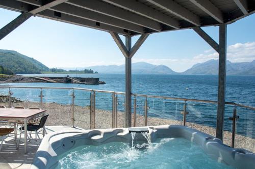 a hot tub with a view of the water at Beach Houses with Hot Tubs in Glencoe