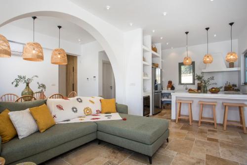 a living room with a couch and a kitchen at Villa Elaia in Afantou