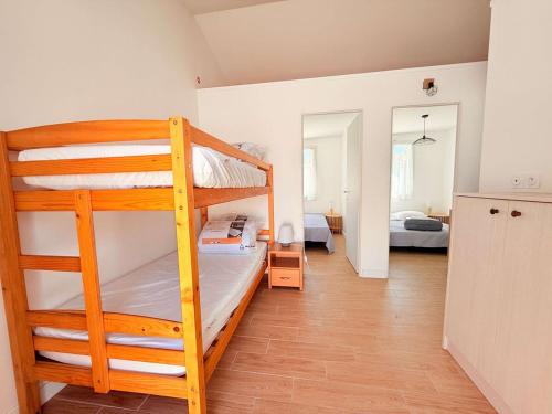 a room with two bunk beds and a hallway at La maison des suisses in Saint-Denis-dʼOléron