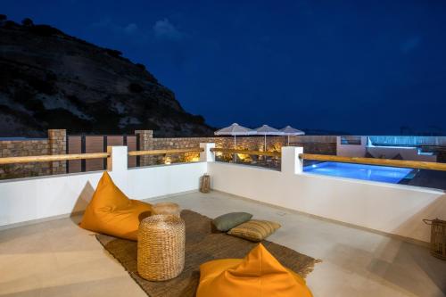 a villa with a swimming pool at night at Villa Elaia in Afantou