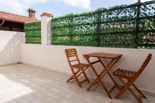 two chairs and a table on a patio at Domu Mena - Domusnovas in Domusnovas