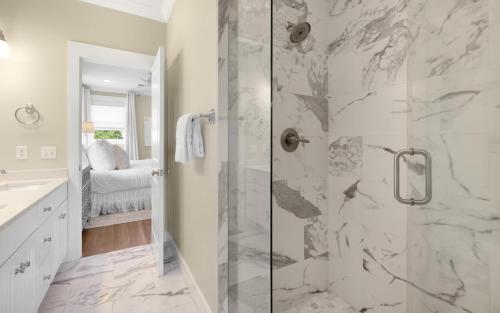 a white bathroom with a shower with a glass door at Ritz Clareon by Oversee 30A in Seacrest