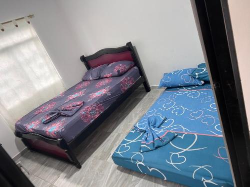 a bedroom with two twin beds and a mirror at Finca Hotel Villa el Ocaso Huila in Rivera