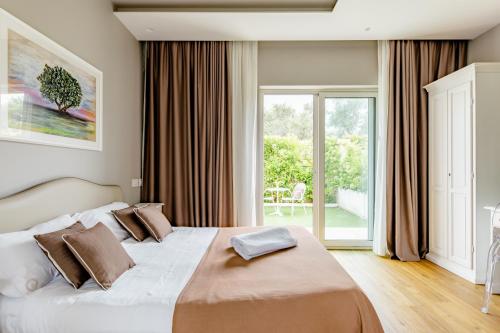 a bedroom with a large bed and a large window at San Marco Antico Relais - B&B in Bitonto