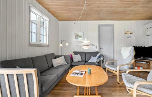 a living room with a couch and a table at Cozy Home In Aakirkeby With Wifi in Vester Sømarken