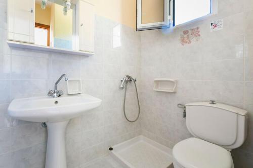 a bathroom with a toilet and a sink at Lourdas View Studios in Vlachata