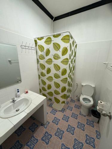 a bathroom with a toilet and a sink and a mirror at Mamma Mia Rooms in Kata Beach