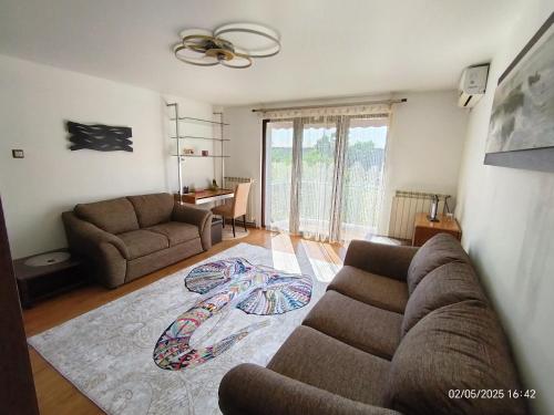 a living room with a couch and a table at ARKA Apartment in Craiova