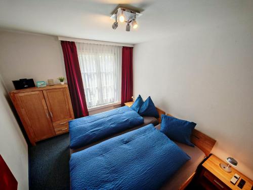 a bedroom with two beds with blue pillows at 4 Zimmer 115m2 Gartenwohnung an der Jakobshorn Talstation neben Wander- und Mountainbikeparadise in Davos