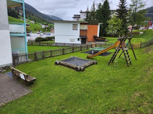 an outdoor playground with a slide and a play equipment at 4 Zimmer 115m2 Gartenwohnung an der Jakobshorn Talstation neben Wander- und Mountainbikeparadise in Davos