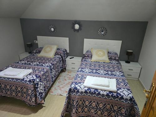 a bedroom with two beds with pillows on them at APARTAMENTO EDITA in Lugo