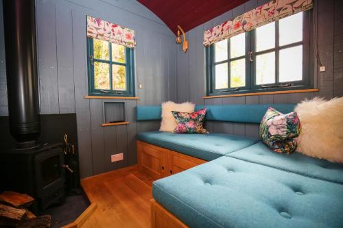 a room with a blue couch and a stove at Lympstone Manor Hotel Restaurant & Vineyard - Relais & Chateaux in Exmouth
