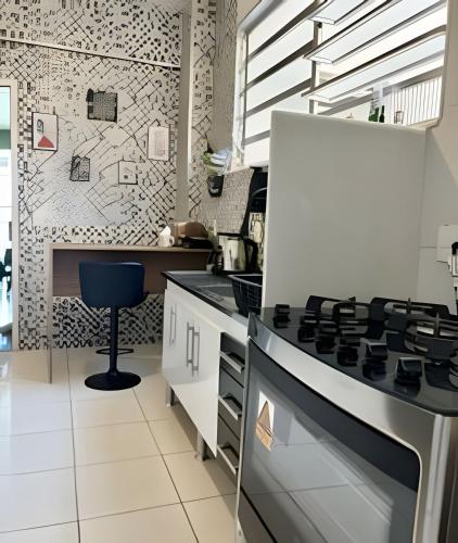 a kitchen with a stove and a chair in it at Vista deslumbrante e conforto em Ipanema in Rio de Janeiro