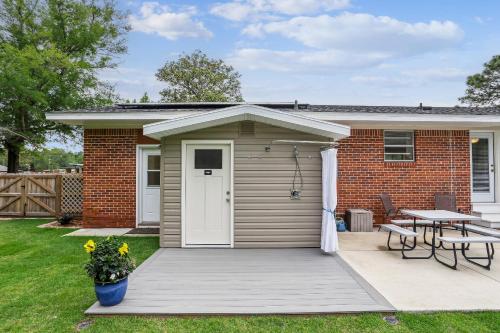a small house with a deck and a table at 2967 Swan Lane in Pensacola