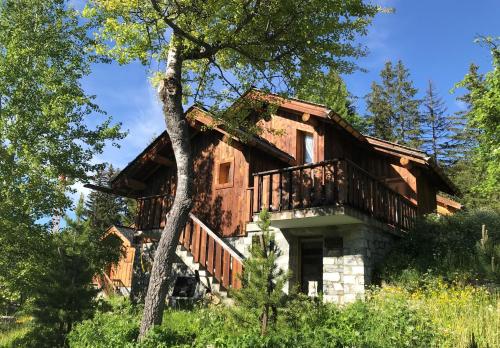 Cette maison en rondins possède un balcon sur le côté. dans l'établissement Meribel Altitude1600 chalet 6 personnes en pleine nature au milieu des pistes, à Méribel