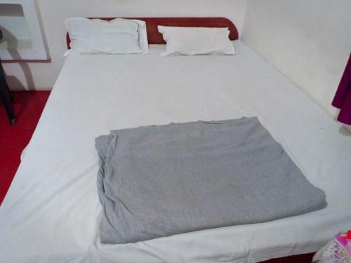 a white bed with white sheets and pillows at hotel shree vishnu guest house in Gaya