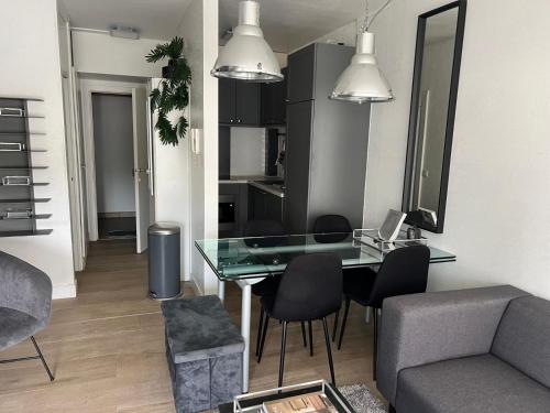 a living room with a glass table and a couch at 2 bedroom apartment at Knokke-Heist, near Zeebrugge, overlooking the lake in Knokke-Heist