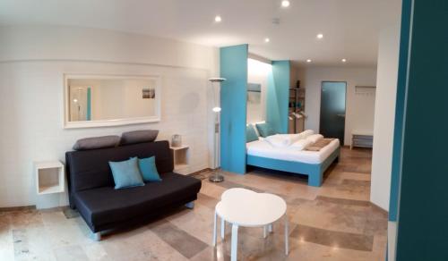 a living room with a couch and a bed at Kabine 7 in Koksijde