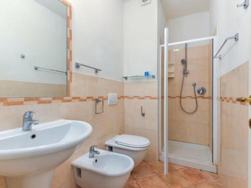 a bathroom with a sink and a toilet and a shower at Appartamenti dolores castle in Marina di Campo Airport