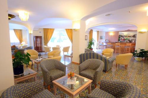 a living room with chairs and a table at Hermitage Resort & Thermal Spa in Ischia