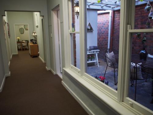a hallway of a house with windows and a table at City Quarters on Brewer in Perth