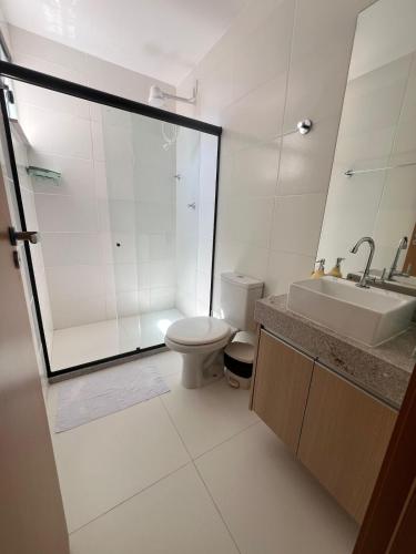 a bathroom with a toilet and a sink and a shower at Casa da Alê in Camaçari