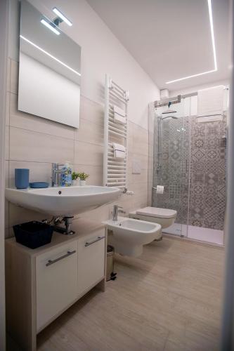 a bathroom with a sink and a toilet and a shower at CASA LILLY camere matrimoniali con bagno privato in Chioggia