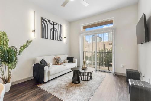 a living room with a couch and a table at Downtown Modern Elegance Suite with Free Parking, Pool, WIFI and a King Bed in Houston