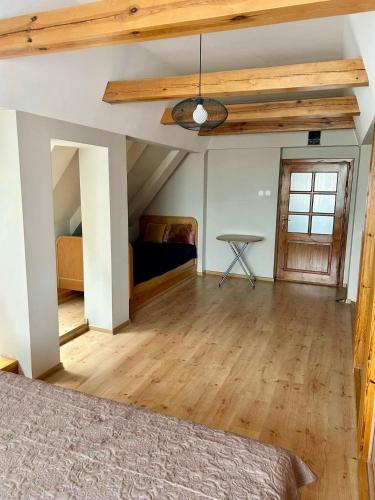 an attic room with a bed and a table at Przy Ratuszu in Chojnice