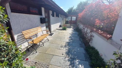 a wooden bench sitting outside of a building at Ferienhaus Berge und See mit Whirlpool und Sauna in Rimsting
