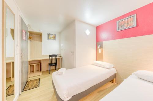 a small room with two beds and a table at FASTHOTEL ROISSY CDG SUD - Claye Souilly in Claye-Souilly