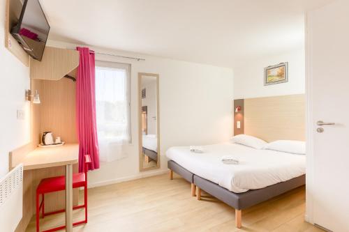 a hotel room with a bed and a tv at FASTHOTEL ROISSY CDG SUD - Claye Souilly in Claye-Souilly