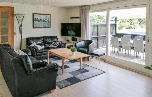 a living room with a couch and a table at 3 Bedroom Beautiful Home In Toftlund in Toftlund