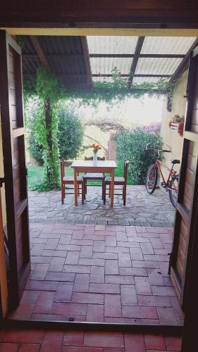 a patio with a table and a bench and a bike at La Bella Vista in Collazzone