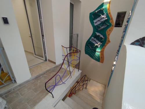 a staircase in a room with a guitar on the wall at La Dimora dell'Artista in Mazara del Vallo