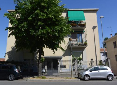 a white car parked in front of a building at Rooms Of Love in Pavia