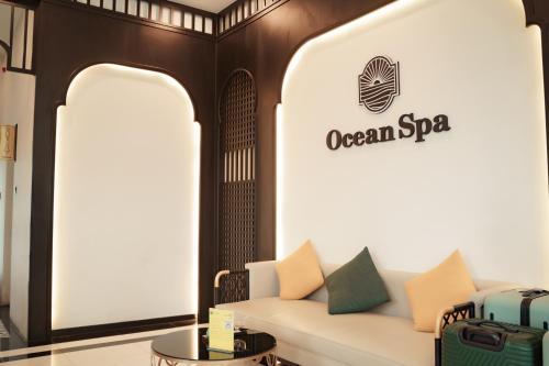 a couch in a room with a sign on the wall at The Lagoon Cam Ranh - Your Perfect Getaway - Free room upgrade in Cam Ranh International Airport
