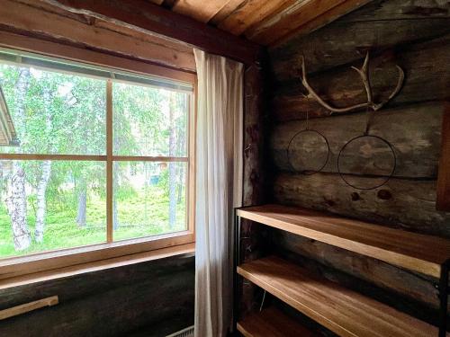 a room with a window in a log cabin at Lapland Lodge Pyhä Ski in, sauna, free WiFi, national park - Lapland Villas in Pyhätunturi