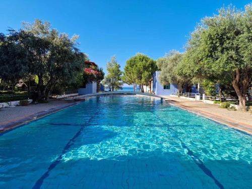 a large swimming pool with blue water at Porto Blue Horizon in Pefkohori