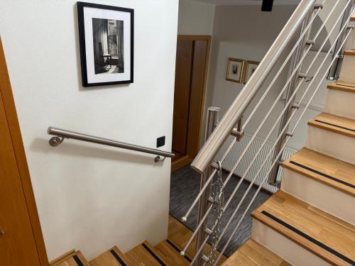 a hallway with stairs with a picture on the wall at A. Bernhard Guest House in Keflavík
