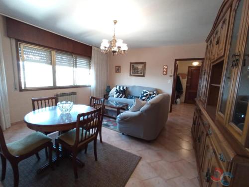 a living room with a table and a couch at Concepción Arenal 175 in Marín