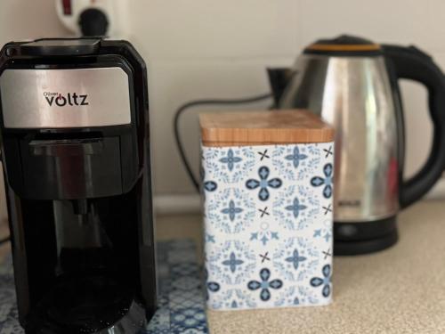 a coffee maker and a coffee pot on a counter at Raya Apartments Siviri Garden in Siviri