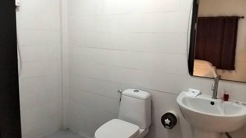 a bathroom with a sink and a toilet and a mirror at แอทชฎา เชียงใหม่ @Shada Chiang Mai in Chom Thong