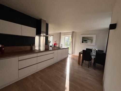 a kitchen and dining room with a table in it at Stone House in Plélan-le-Petit