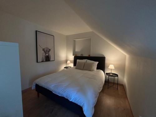 a bedroom with a large bed in a attic at Stone House in Plélan-le-Petit