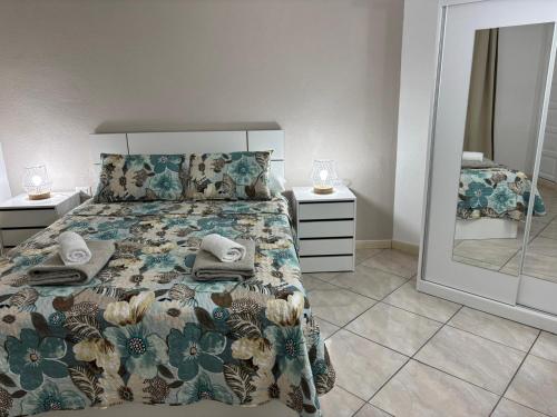 a bedroom with a bed and a large mirror at Casa Serena in Los Cristianos
