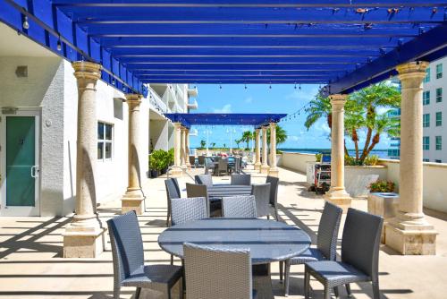 a patio with tables and chairs and the ocean at LUXURY 2 Bedroom Apartment At BRICKELL with pool in Miami