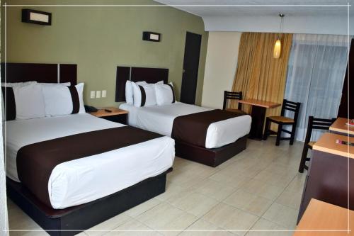 Una cama o camas en una habitación de Hotel Real de Minas Tradicional