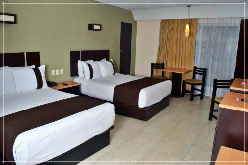 Una cama o camas en una habitación de Hotel Real de Minas Tradicional